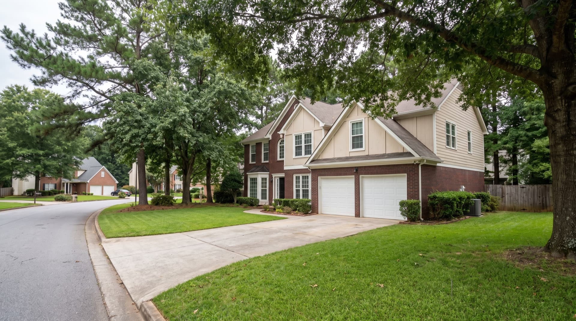 Brick-front home with painted siding and mature trees in Duluth, Georgia