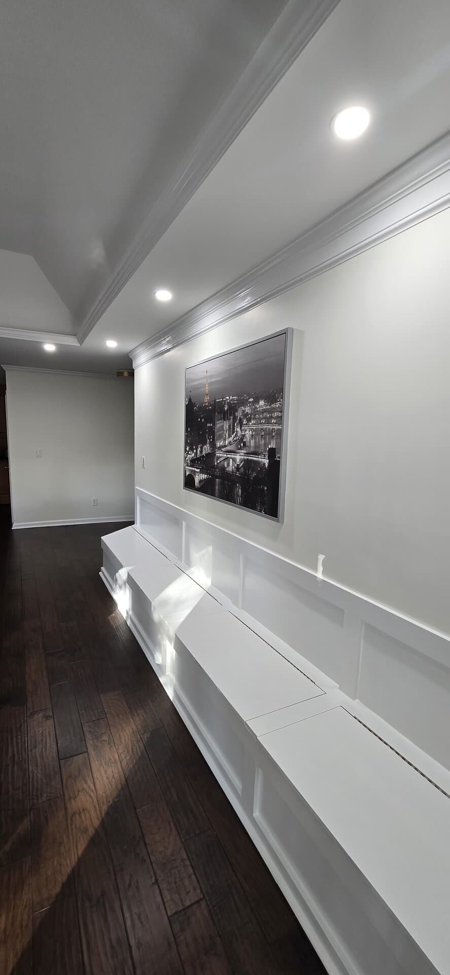 Premium hallway with custom wainscoting, crown molding, and crisp white trim